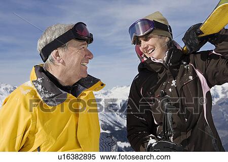 Mature couple in ski-wear holding Skis on mountain View Large Photo Image Stock Photography - Mature couple in ski-wear holding Skis on mountain. Fotosearch