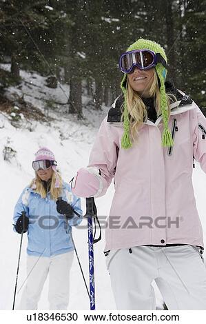Two young blonde women standing in forest wearing snow-shoes, portrait View Large Photo Image Stock Image - Two young blonde women standing in forest wearing snow-shoes, portrait. Fotosearch