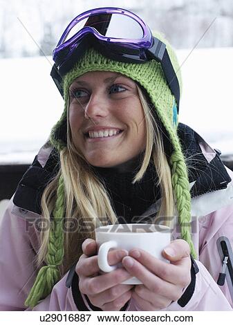 Young woman in ski-wear with cup of hot chocolate, close-up, portrait View Large Photo Image Stock Photo - Young woman in ski-wear with cup of hot chocolate, close-up, portrait. Fotosearch