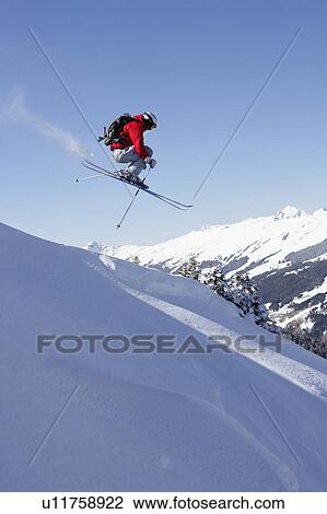 Austria, Saalbach, male skier jumping down slope View Large Photo Image Stock Image - Austria, Saalbach, male skier jumping down slope. Fotosearch
