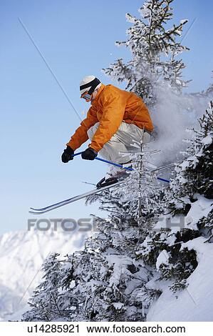 Austria, Saalbach, male skier jumping through trees on slope View Large Photo Image Stock Image - Austria, Saalbach, male skier jumping through trees on slope. Fotosearch
