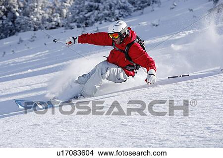 Austria, Saalbach, man skiing down slope, smiling View Large Photo Image Picture - Austria, Saalbach, man skiing down slope, smiling. Fotosearch