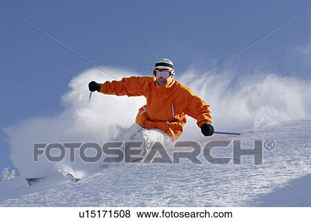 Austria, Saalbach, man wearing goggles skiing down slope View Large Photo Image Stock Photo - Austria, Saalbach, man wearing goggles skiing down slope. Fotosearch