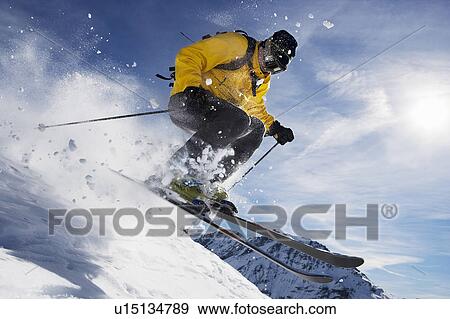 Male skiing over mountain ridge View Large Photo Image Stock Photo - Male skiing over mountain ridge. Fotosearch