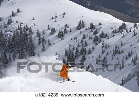 Stock Photo - Man skiing down snow mountain slope, overhead view. Fotosearch