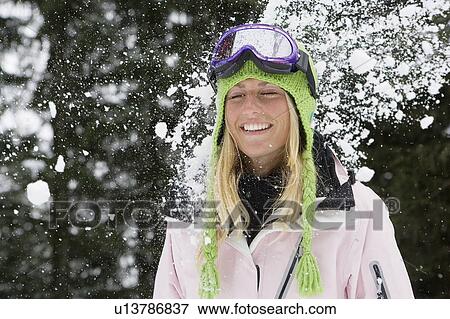 Snowball exploding on young blonde woman wearing ski-wear in forest View Large Photo Image Stock Photo - Snowball exploding on young blonde woman wearing ski-wear in forest. Fotosearch