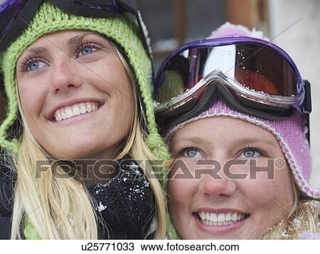 Stock Image - Two young blonde women in ski-wear, close-up, portrait. Fotosearch