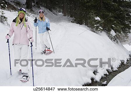 Two young blonde women in snow shoes near brook, portrait View Large Photo Image Stock Photo - Two young blonde women in snow shoes near brook, portrait. Fotosearch