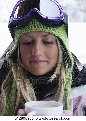 Young woman in ski-wear with cup of hot chocolate, close-up, portrait View Large Photo Image Stock Photography - Young woman in ski-wear with cup of hot chocolate, close-up, portrait. Fotosearch