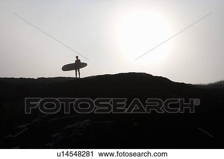 Man standing with surfboard. View Large Photo Image Stock Image - Man standing with surfboard.. Fotosearch