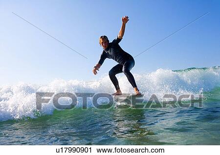 Stock Image - Man surfing a wave.. Fotosearch