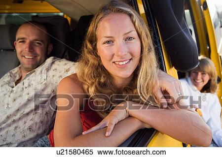 Couple in a van smiling with a woman in background. View Large Photo Image Stock Photography - Couple in a van smiling with a woman in background.. Fotosearch