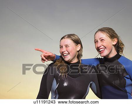 Portrait of two female surfers. View Large Photo Image Stock Image - Portrait of two female surfers.. Fotosearch
