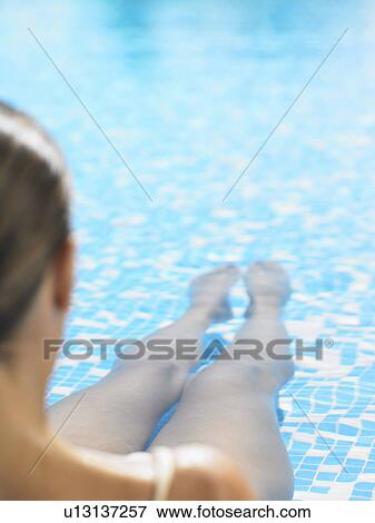 A woman in the shallows of a pool View Large Photo Image Stock Photo - A woman in the shallows of a pool . Fotosearch