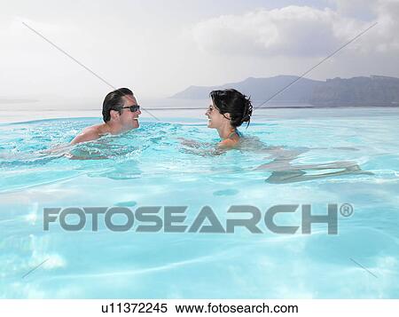 Couple in swimming pool View Large Photo Image Stock Photography - Couple in swimming pool. Fotosearch