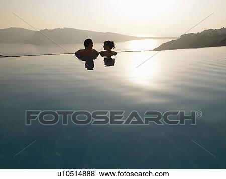Couple in swimming pool, sunset View Large Photo Image Stock Photo - Couple in swimming pool, sunset. Fotosearch