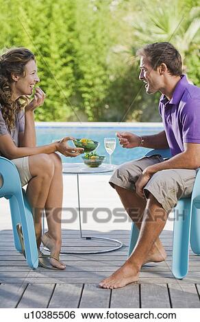 Couple on a wooden terrace by a pool View Large Photo Image Stock Photograph - Couple on a wooden terrace by a pool. Fotosearch