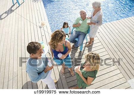 Family on a wooden terrace by a pool View Large Photo Image Stock Photography - Family on a wooden terrace by a pool. Fotosearch