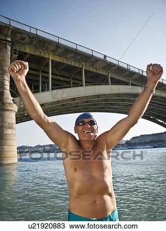 Man celebrating by river View Large Photo Image Stock Image - Man celebrating by river. Fotosearch