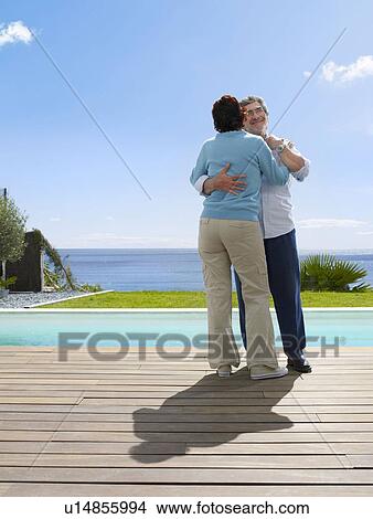 Picture - Mature man and woman dancing outside. Fotosearch