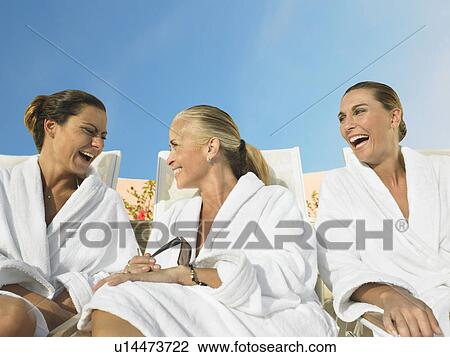 Three ladies relaxing in the sun View Large Photo Image Stock Image - Three ladies relaxing in the sun . Fotosearch