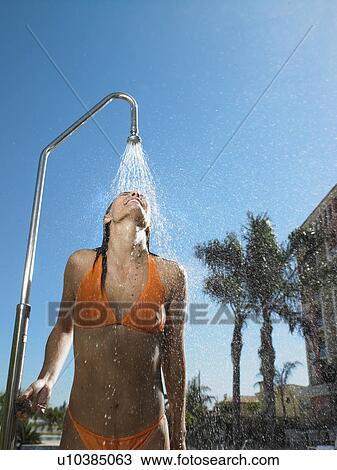 Woman having out door shower View Large Photo Image Stock Image - Woman having out door shower . Fotosearch