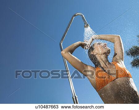 Woman having out door shower View Large Photo Image Stock Image - Woman having out door shower . Fotosearch
