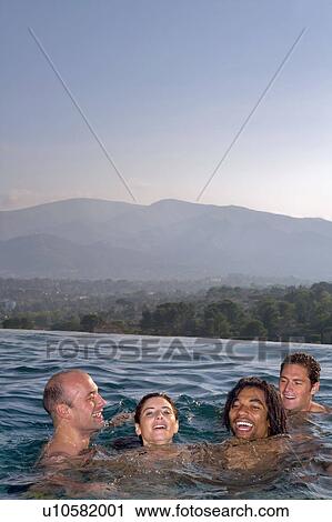 Young men and woman in a pool View Large Photo Image Stock Image - Young men and woman in a pool. Fotosearch