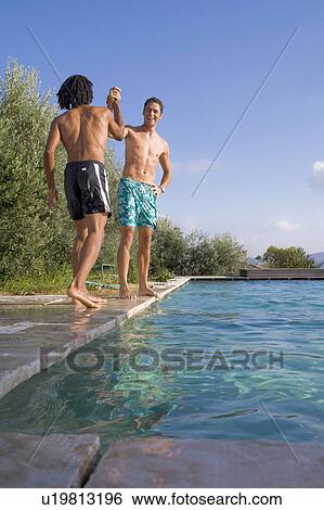 Young men at a pool View Large Photo Image Stock Photograph - Young men at a pool. Fotosearch