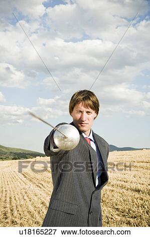Businessman fencing in wheat field. View Large Photo Image Stock Photo - Businessman fencing in wheat field.. Fotosearch
