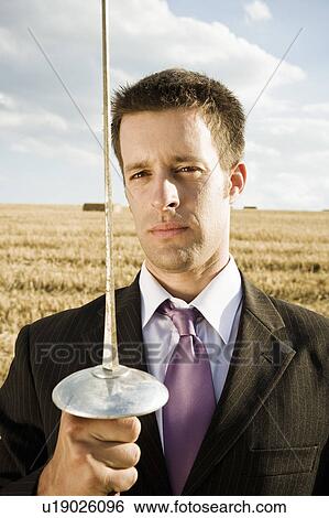 Businessman fencing in wheat field. View Large Photo Image Stock Photograph - Businessman fencing in wheat field.. Fotosearch