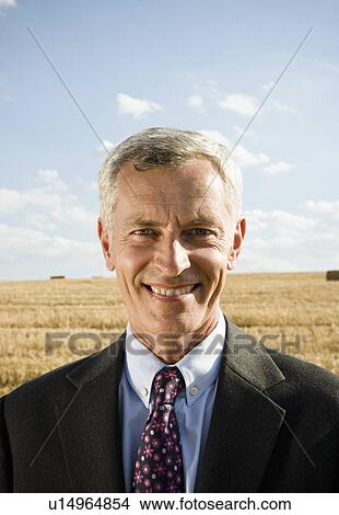 Businessman in a wheat field. View Large Photo Image Picture - Businessman in a wheat field.. Fotosearch