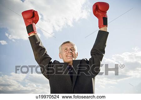 Businessman wearing boxing gloves. View Large Photo Image Picture - Businessman wearing boxing gloves.. Fotosearch