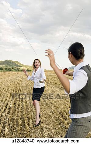 Businesspeople fencing in a wheat field. View Large Photo Image Stock Image - Businesspeople fencing in a wheat field.. Fotosearch
