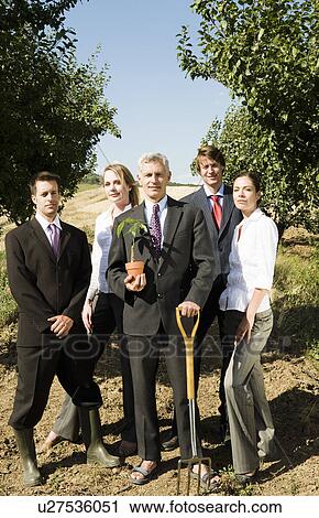 Group of businesspeople in an orchard. View Large Photo Image Stock Image - Group of businesspeople in an orchard.. Fotosearch