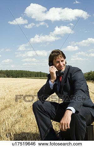 Stock Photograph - Man on old phone in wheat field.. Fotosearch
