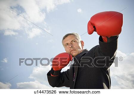 Businessman wearing boxing gloves. View Large Photo Image Stock Photograph - Businessman wearing boxing gloves.. Fotosearch