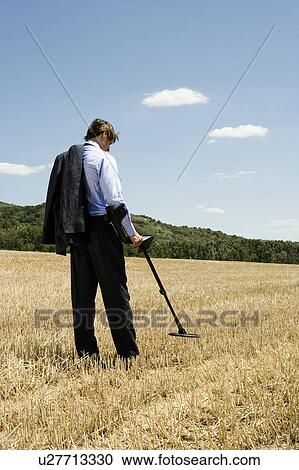 Businessman with metal detector outdoors. View Large Photo Image Stock Image - Businessman with metal detector outdoors.. Fotosearch