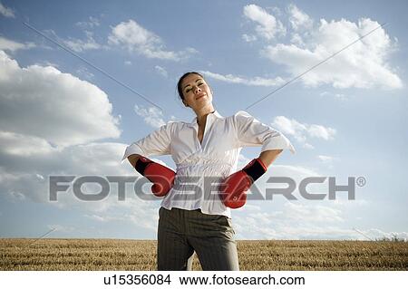 Businesswoman in wheat field wearing boxing gloves. View Large Photo Image Picture - Businesswoman in wheat field wearing boxing gloves.. Fotosearch