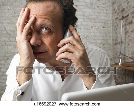Stock Photo - Stressed businessman talking on the telephone., Brussels, Belgium.. Fotosearch