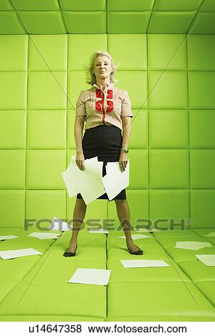 Woman standing with papers around her in a green padded cell View Large Photo Image Stock Photo - Woman standing with papers around her in a green padded cell. Fotosearch