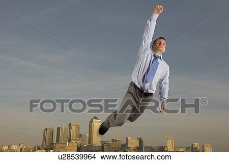 Businessman flying over the city View Large Photo Image Picture - Businessman flying over the city. Fotosearch