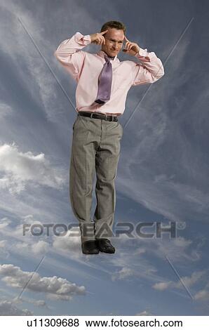 Stock Photo - Businessman in the sky with hands to head. Fotosearch