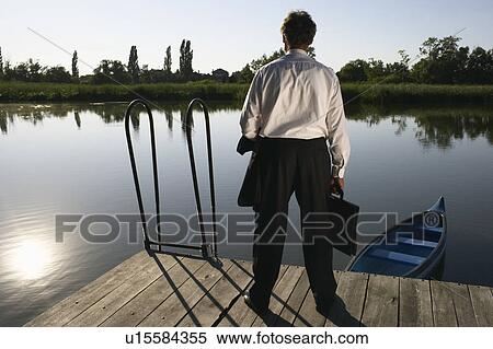 Businessman standing on Pier. View Large Photo Image Stock Photography - Businessman standing on Pier.. Fotosearch