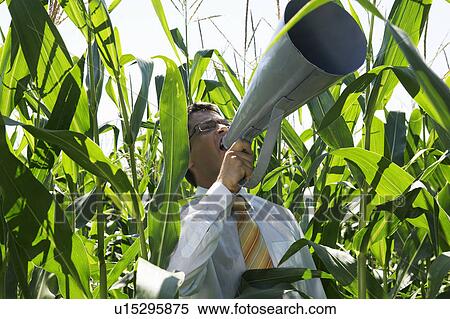 Businessman with megaphone in cornfield. View Large Photo Image Stock Photography - Businessman with megaphone in cornfield.. Fotosearch