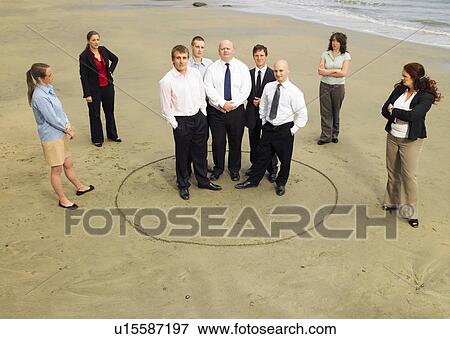 Stock Photo - Group of businesspeople on the beach.. Fotosearch