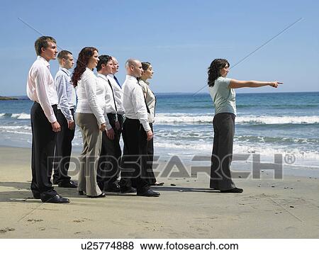 Stock Photo - Group of businesspeople on the beach.. Fotosearch