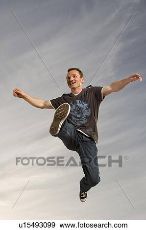 Stock Photo - Man leaping through the air. Fotosearch