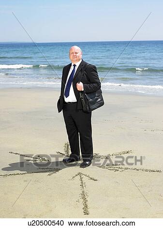 Man on beach with arrows in sand around him. View Large Photo Image Stock Image - Man on beach with arrows in sand around him.. Fotosearch