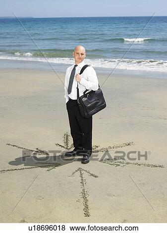 Man on beach with arrows in sand around him. View Large Photo Image Stock Photo - Man on beach with arrows in sand around him.. Fotosearch